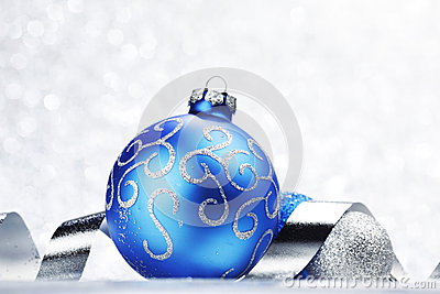 Blue Christmas Ball And Ribbon On Abstract Glitter Silver Background