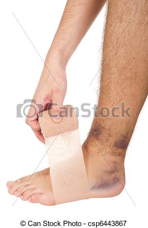 Young Male With Sprained Ankle Applying Medical Bandage  Isolated On