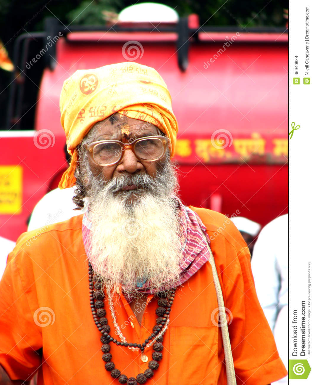 India Wearing A Traditional Saffron Attire And Holy Bead Necklaces