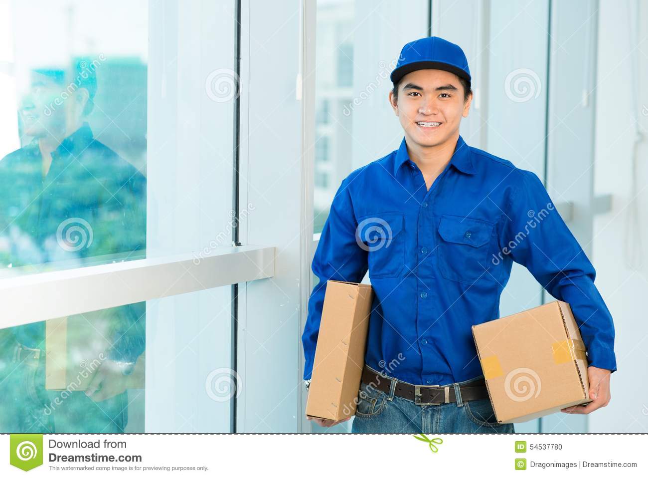 Portrait Of Smiling Vietnamese Delivery Man Holding Parcels