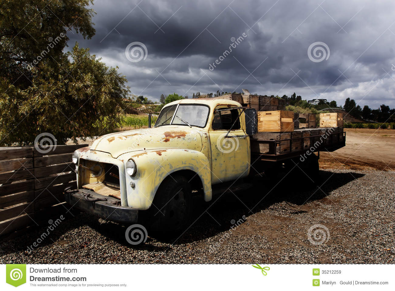 An Old Gmc Flatbed Truck With Faded Yellow Paint And Rust Spots