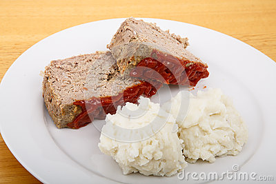Serving Of Meatloaf And Mashed Potatoes On A White Plate