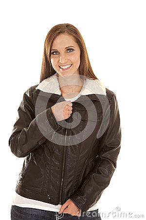 Woman With A Smile On Her Face Zipping Up Her Jacket