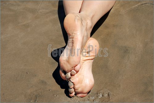 Image Of Crossed Feet In Sand  Stock Picture To Download At