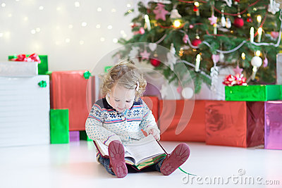Warm Knitted Jacket Reading A Book Under A Beautiful Christmas Tree