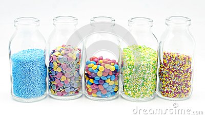Candy Sprinkles On A Glass Bottle On White Background