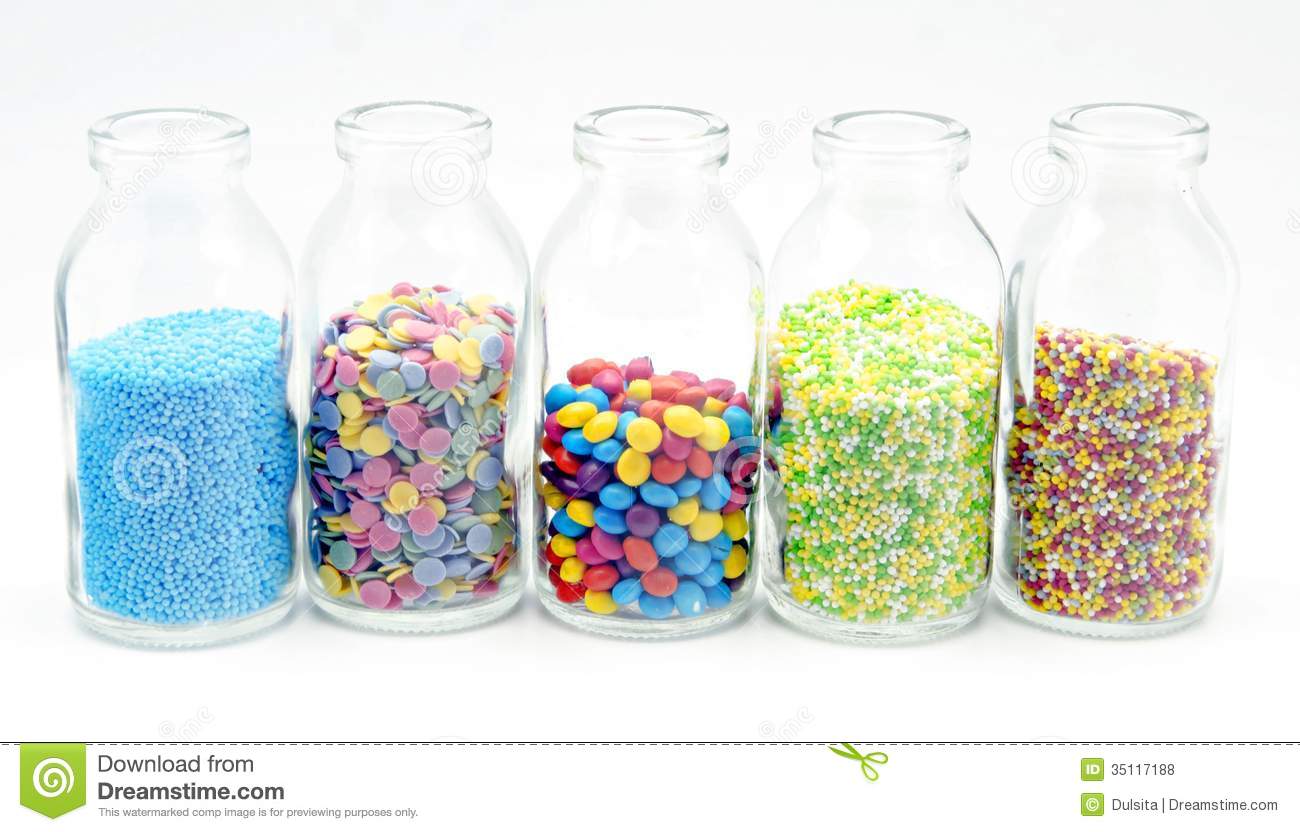 Candy Sprinkles On A Glass Bottle On White Background