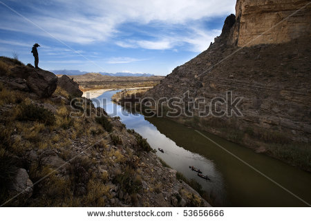 Cliffs Looking Over River At Canoes Down In The Water   Stock Photo