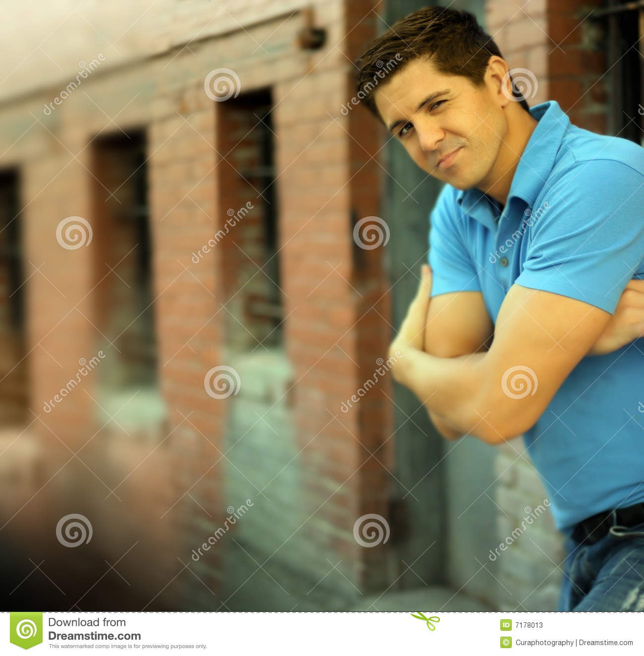 Of Young Good Looking Male Model With Folded Arms While Winking