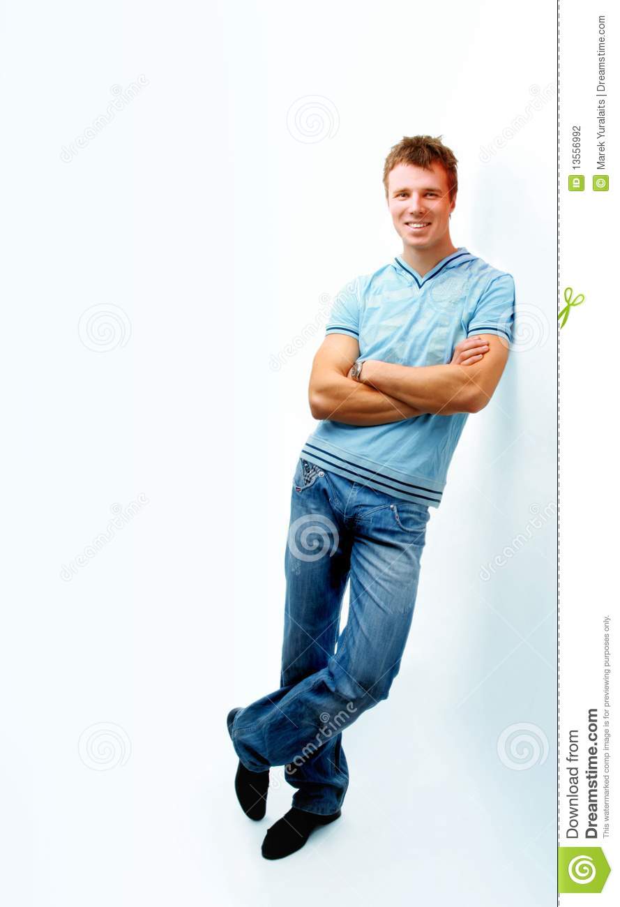 Cheerful Young Man Leaning Against Wall  Isolated On White Background