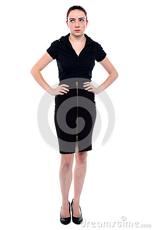Frustrated Business Woman Standing With Her Hands On Her Hips Looking